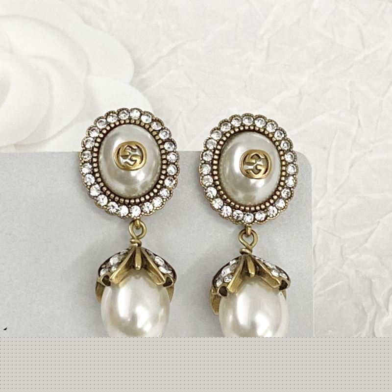 G*u*i earrings